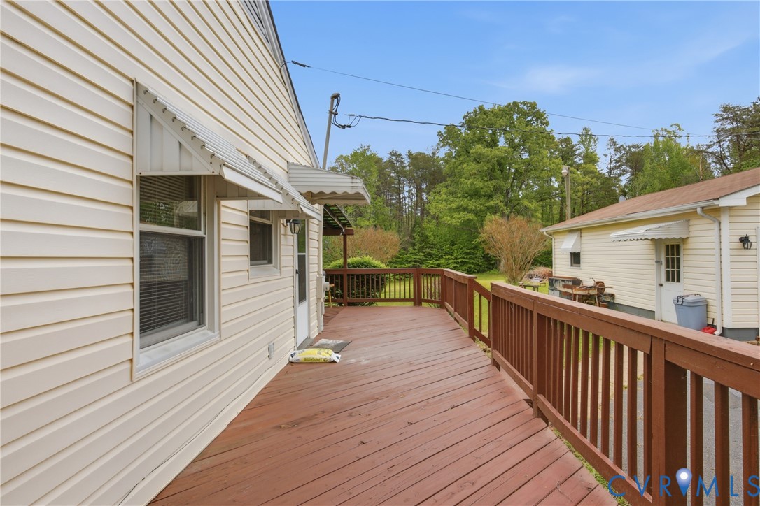3590 Belle Meade Road Bumpass, VA 23024 - Photo 13 of 20 a view of a balcony with wooden floor and fence and a potted plant