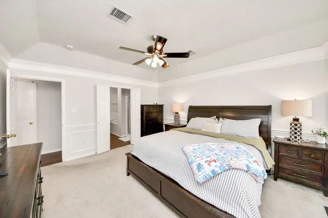 a bedroom with a bed and a chandelier