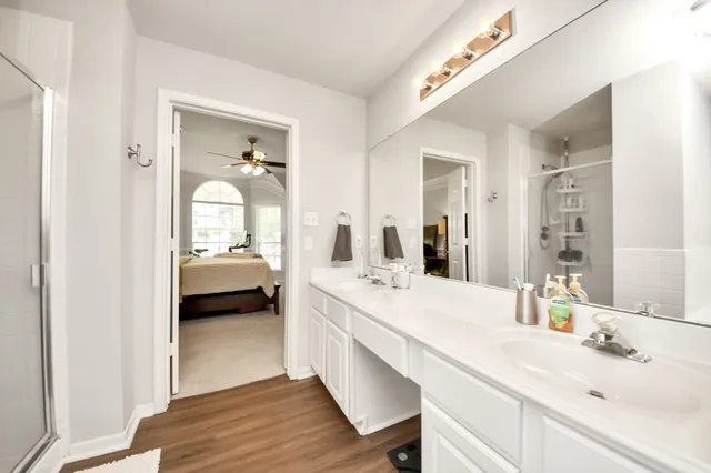 a en suite bathroom with a double vanity sink and a mirror