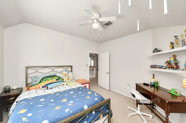 a view of a house with a backyard and a tree