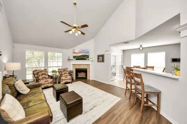 a living room with furniture fireplace and dining table