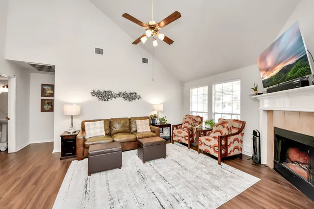 a living room with furniture fireplace and flat screen tv