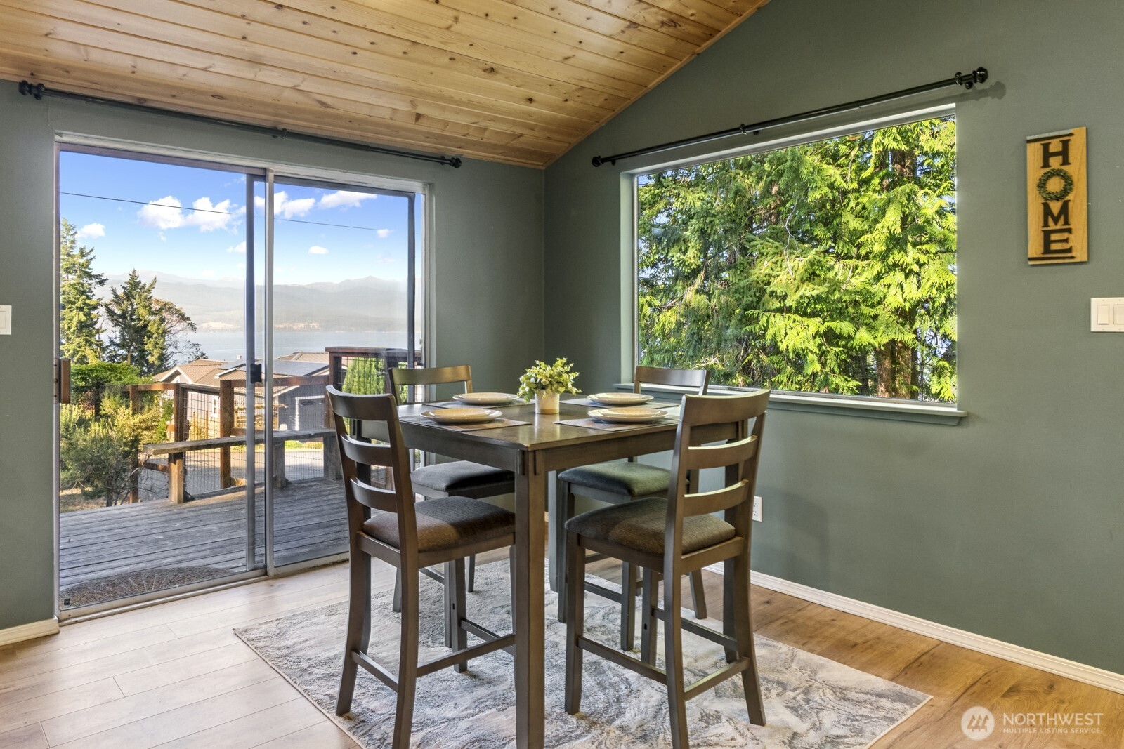 71 Quinault Loop Port Townsend, WA 98368 - Photo 8 of 29 a view of a dining room with furniture window and wooden floor