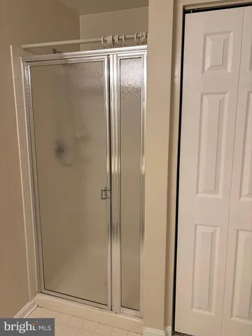 a bathroom with a glass shower door