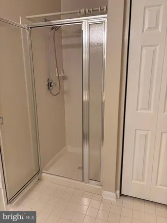a bathroom with a glass door shower