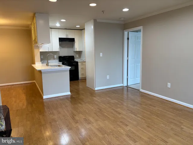 a view of a kitchen with a sink and a stove top oven