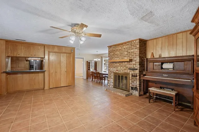 a view of kitchen with furniture and refrigerator