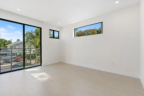 a view of an empty room with a balcony