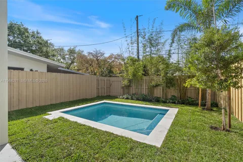 a view of a backyard with a small pool