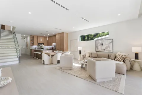 a living room with furniture white and a couch