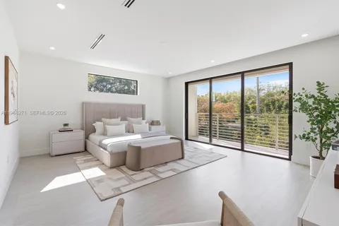 a living room with furniture and large windows