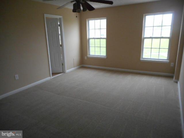 9744 Luguna Road Baltimore, MD 21220 - Photo 22 of 30 an empty room with windows and closet