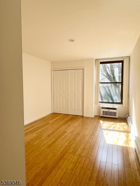 21 River Road, Unit G Nutley, NJ 07110 - Photo 15 of 22 an empty room with wooden floor and windows