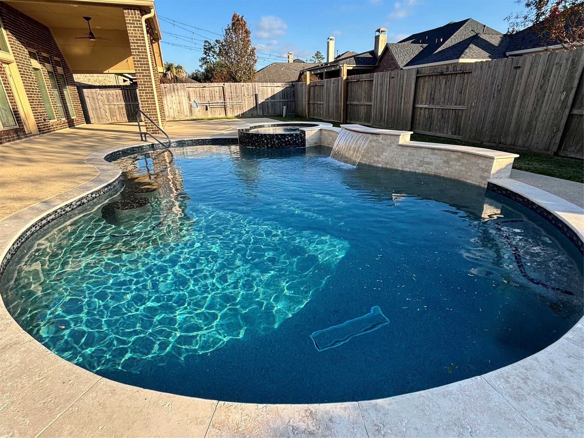 13506 Breakwater Path Loop Houston, TX 77044 - Photo 29 of 42 Brand new luxury, salt water pool/spa with blue plaster, featuring a hot tub with bluetooth connection for ease of access. Pool changes colors via the app.