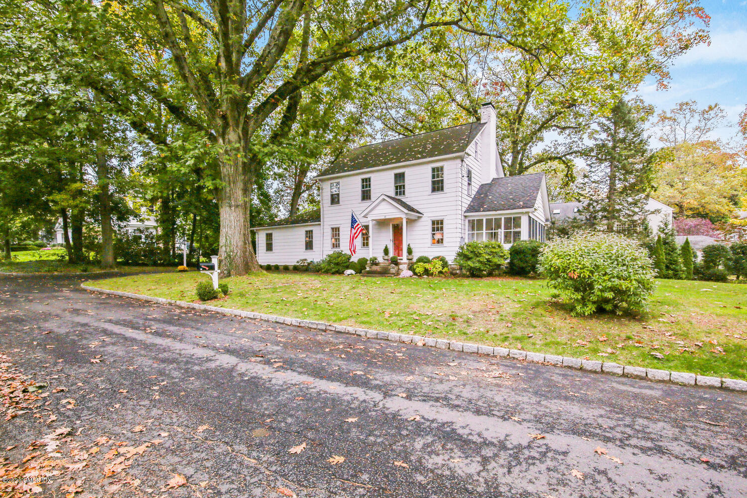 45 Lake Drive South, Unit SOUTH Riverside, CT 06878 - Photo 1 of 1 a view of a house with a big yard and large trees