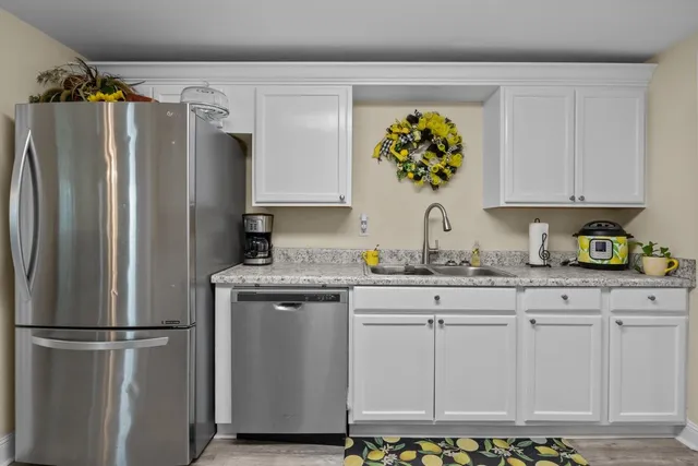 a kitchen with appliances a sink and cabinets