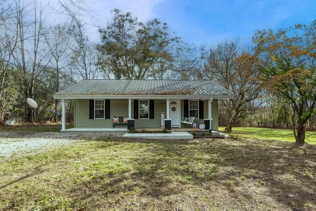 a front view of a house with a yard table and chairs