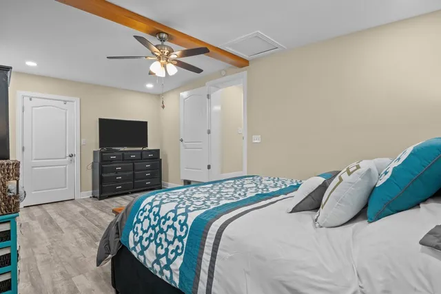 a bedroom with a bed and a television