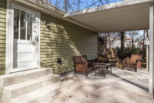 a backyard of a house with outdoor seating