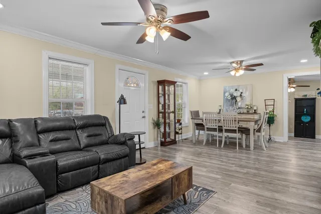 a living room with furniture a dining table and a piano