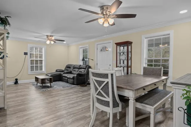 a view of a dining room with furniture window and wooden floor
