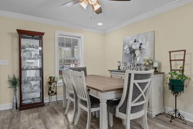a view of a dining room with furniture and wooden floor