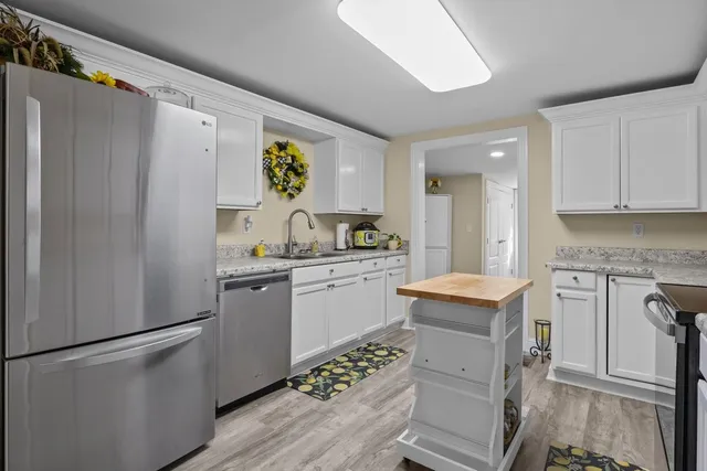 a kitchen with a refrigerator and a sink