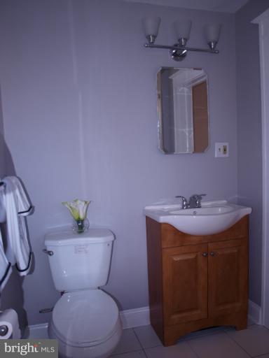 520 Wilton Road Towson, MD 21286 - Photo 11 of 13 a bathroom with a toilet sink and mirror