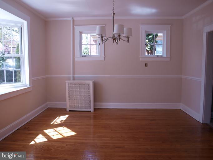 520 Wilton Road Towson, MD 21286 - Photo 3 of 13 an empty room with wooden floor and windows