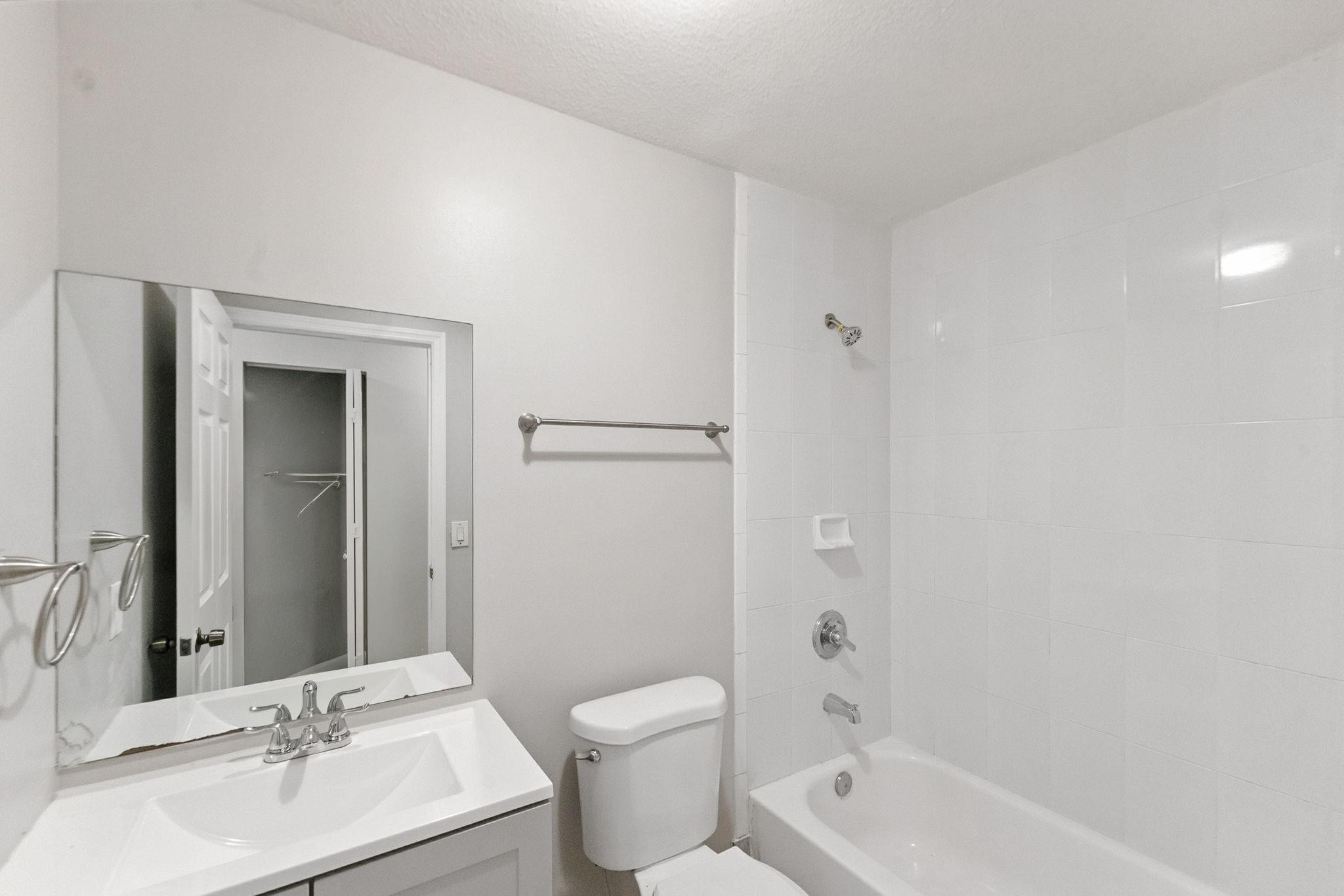 25355 Southwest 135th Court Homestead, FL 33032 - Photo 27 of 40 a bathroom with a bathtub shower sink mirror vanity and toilet
