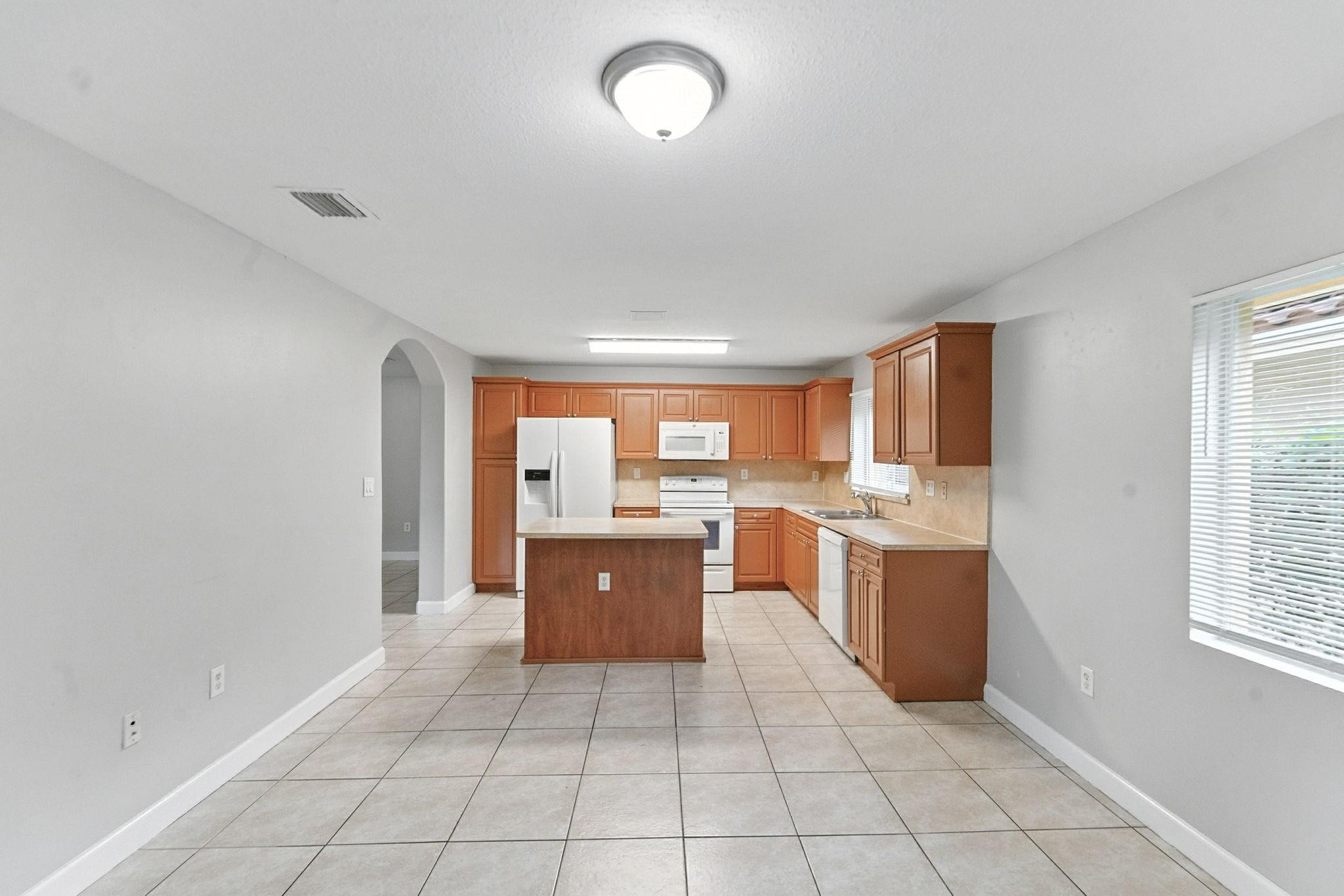 25355 Southwest 135th Court Homestead, FL 33032 - Photo 7 of 40 a open kitchen with cabinets and a stove