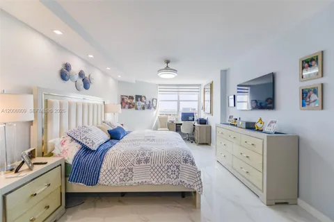 a spacious bedroom with double bed and a window