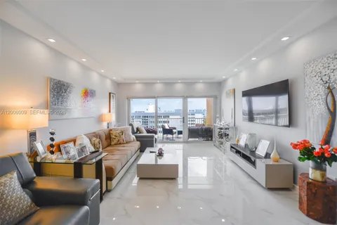 a living room with furniture and flowers