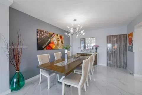a view of a dining room with furniture and chandelier