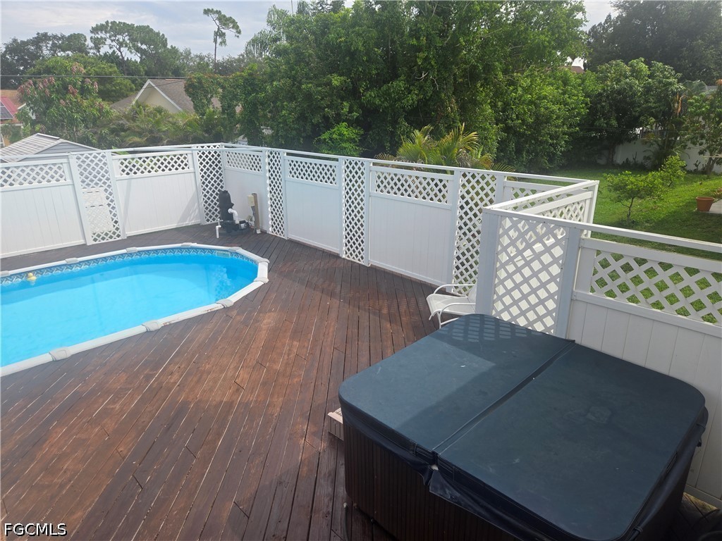 8093 Anhinga Road Fort Myers, FL 33967 - Photo 37 of 49 a view of a roof deck with couches wooden fence and floor