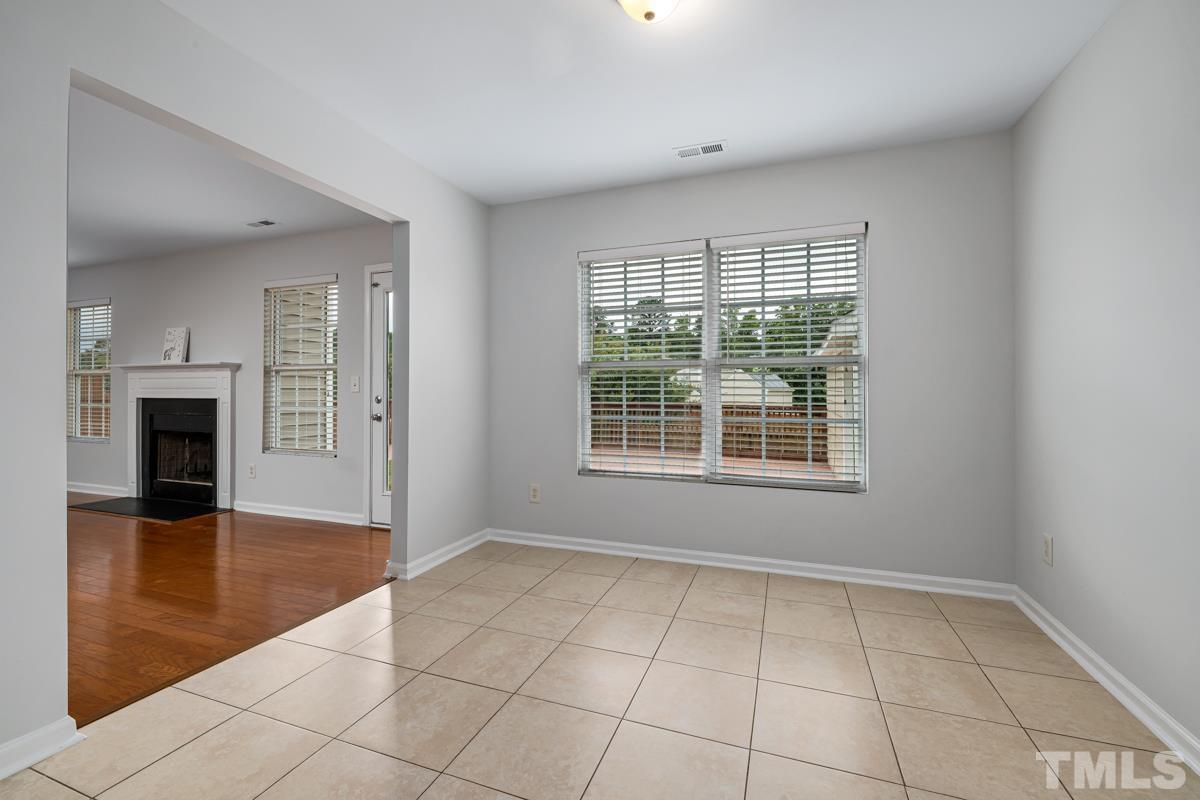 3739 Burtons Barn Street Raleigh, NC 27610 - Photo 12 of 42 a view of an empty room with glass door and wooden floor