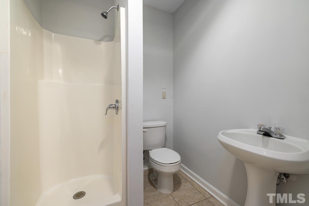 3739 Burtons Barn Street Raleigh, NC 27610 - Photo 20 of 42 a bathroom with a sink a toilet and shower