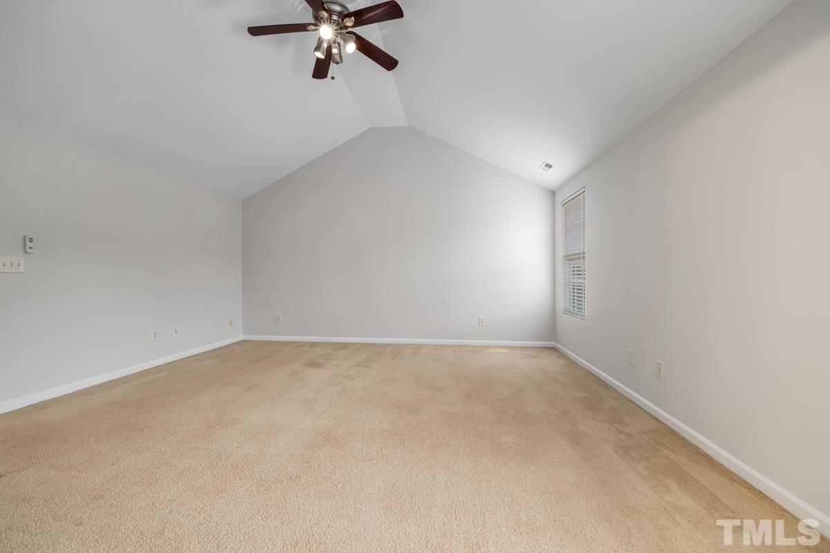 3739 Burtons Barn Street Raleigh, NC 27610 - Photo 28 of 42 an empty room with a ceiling fan and window