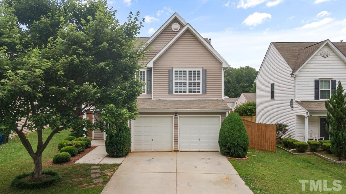 3739 Burtons Barn Street Raleigh, NC 27610 - Photo 39 of 42 a front view of a house with a garden