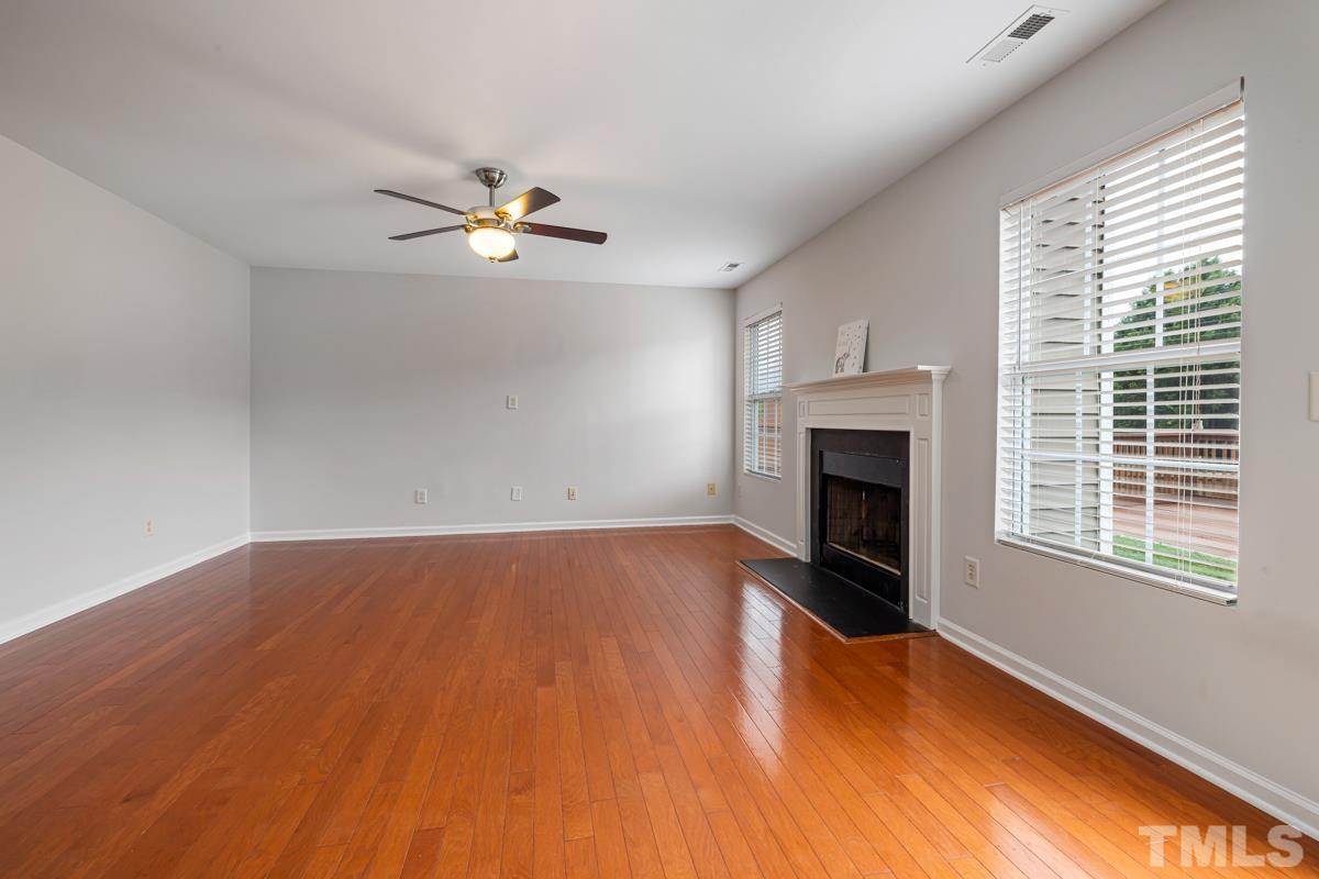 3739 Burtons Barn Street Raleigh, NC 27610 - Photo 10 of 42 an empty room with windows and fireplace