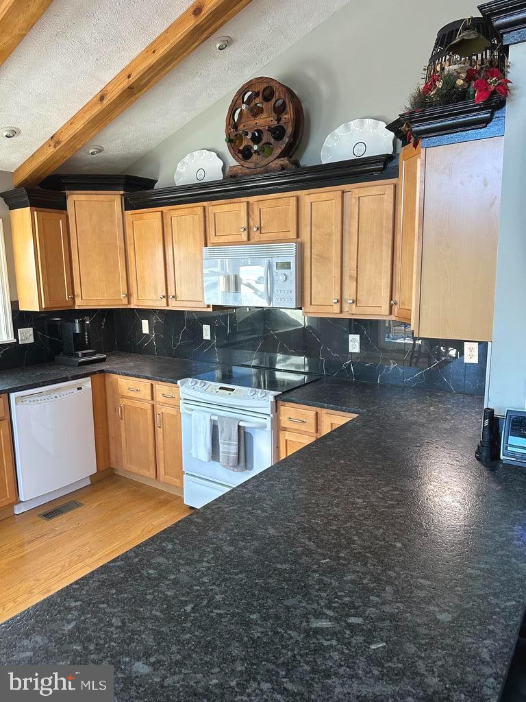 400 Locust Ridge Moorefield, WV 26836 - Photo 19 of 87 a large kitchen with granite countertop a stove and a large window