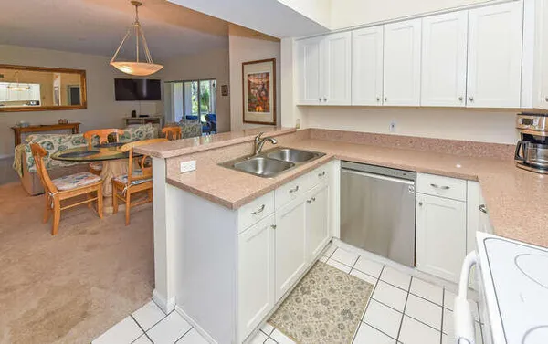 a kitchen with a sink a stove and cabinets