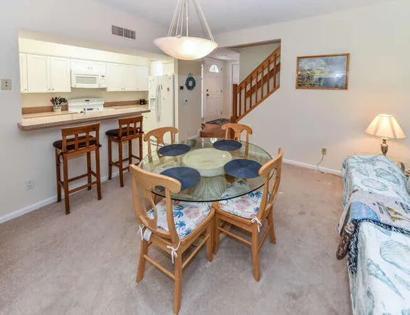 a spacious bedroom with a bed and a flat tv screen on dresser