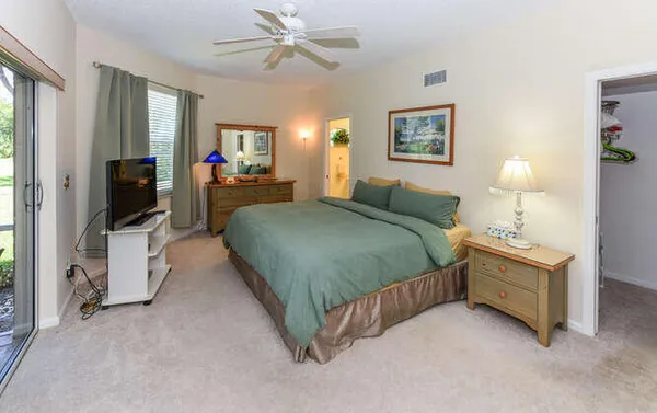 a bed room with a bed mirror and a window