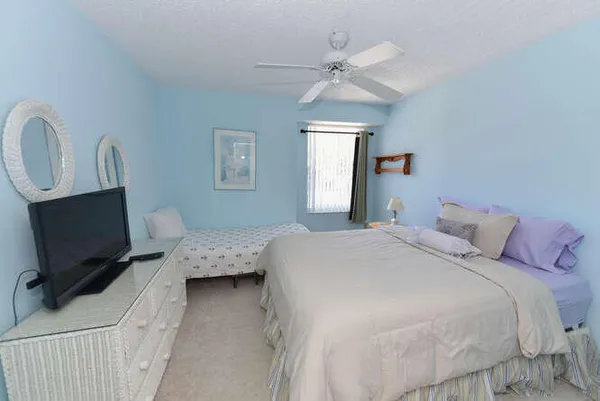 a spacious bathroom with a toilet sink and mirror