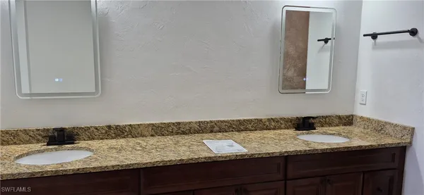 a white toilet sitting next to a white sink