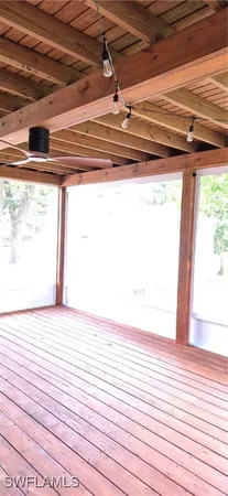 a view of a room with wooden floor and a large window