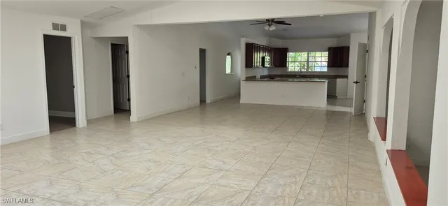 an empty room with a kitchen and a sink