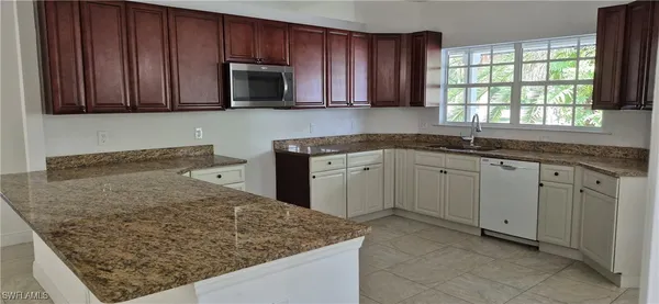 a kitchen with sink cabinets and window