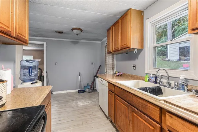 a kitchen with a sink a stove and cabinets